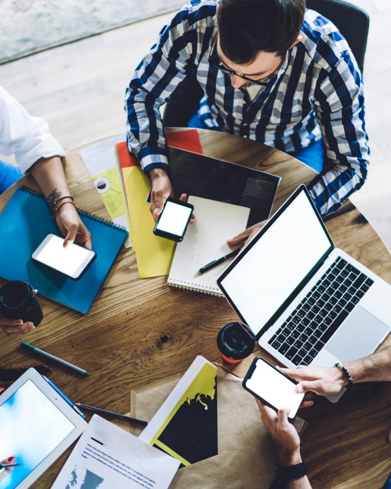 Group of freelancers browsing advertising publication